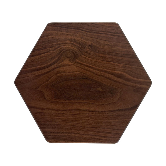 Hexagon-shaped charcuterie board made from sustainably sourced American walnut with a food-safe finish and beveled edges, offering a modern, geometric serving surface for meats, cheeses, fruits, or desserts.