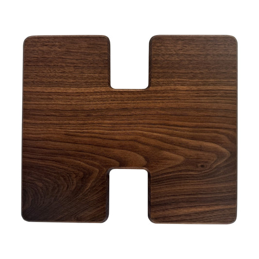 Letter H-shaped charcuterie board made from sustainably sourced American walnut with a food-safe finish and beveled edges, perfect for serving meats, cheeses, fruits, or desserts at personalized gatherings or initial-themed events.